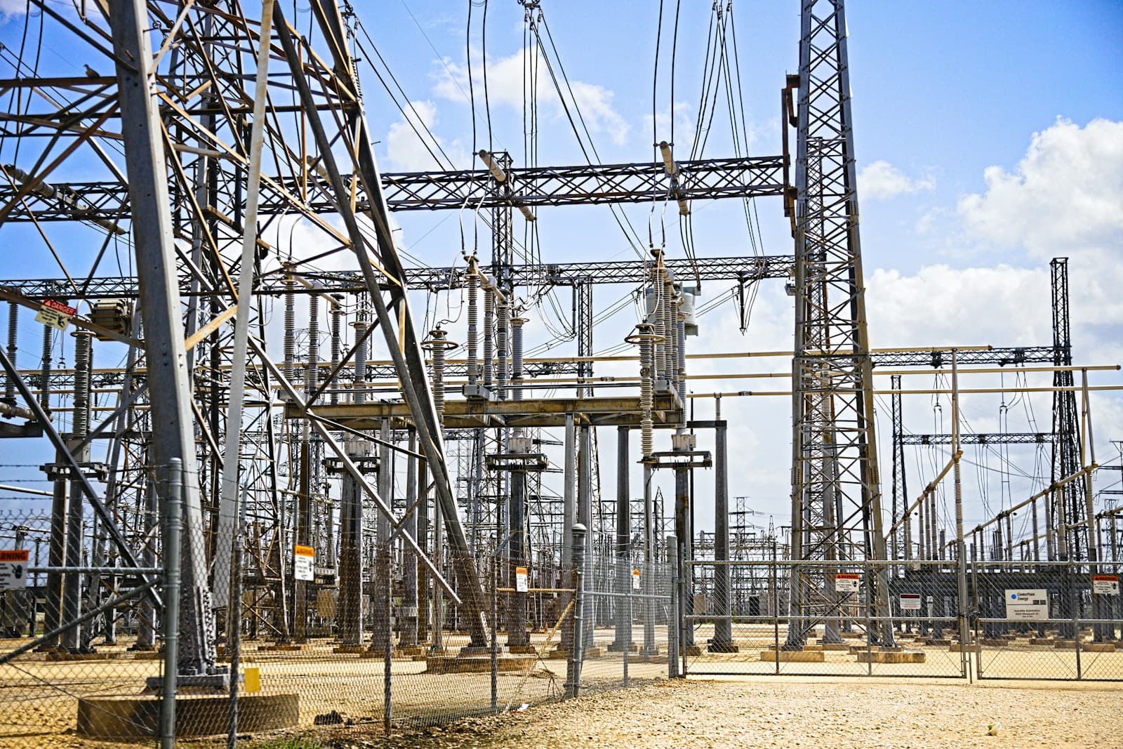 Transformers and busbars of an electrical substation under a grey sky